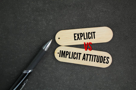 pen and stick with the words What is the Difference Between Explicit and Implicit Attitudes. Explicit attitudes are attitudes that are at the conscious level, are deliberately formの写真素材