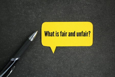 pen and conversation column with questions What is fair and unfair? the concept of seeking justiceの写真素材