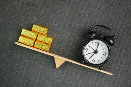 The balance between time and gold represents the trade-off between wealth and time management. It highlights the value of time as an irreplaceable resource, often compared to gold,の写真素材