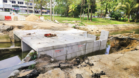 Malaysia, Kuala Terengganu 27 November 2024: a small collapsed bridge is being repaired. Reconstruction of the damaged road after the flood water was washed away by fast waterの写真素材