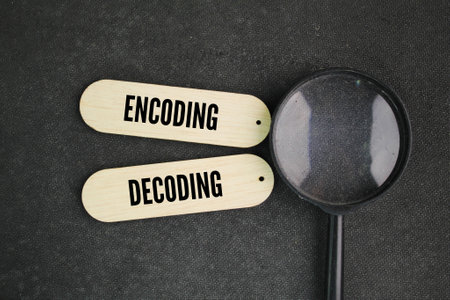 magnifying glass and stick with the words encoding and decoding. A model of encoding or decoding...