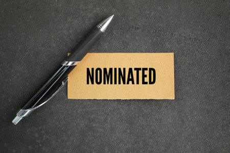 pen and paper with the word nominated. the concept of being employed or qualified. concept acceptedの写真素材