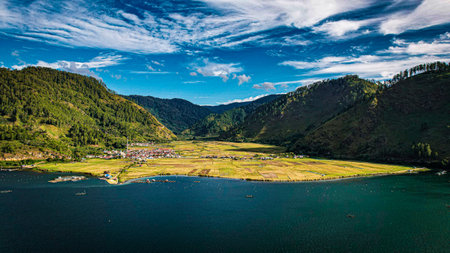 Aerial view of a village on the shore of a mountain lakeの写真素材