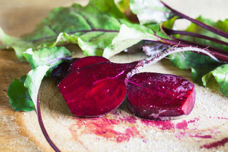 Photo of a farm grown fresh sliced beetroot on wooden background. Macro photo of a vegetable with...