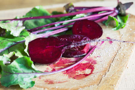 Photo of a farm grown fresh sliced beetroot on wooden background. Macro photo of a vegetable with...