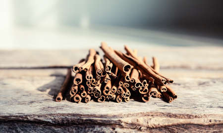 Closeup of cinnamon and star anise seeds on a wooden background. Sunny still life photo. Shallow depth of fieldの写真素材