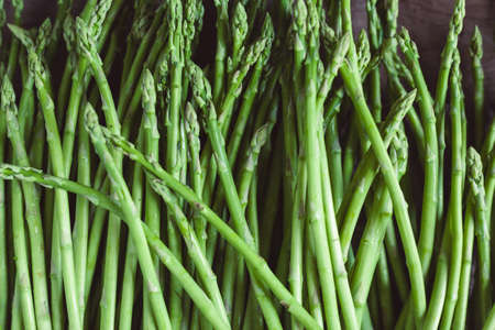 Bunch of fresh asparagus on wooden table. Healthy food photo series.の写真素材