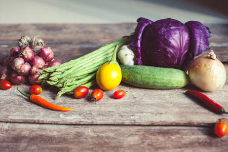 Farm market photo with different vegetables and greens. Organic products and healthy lifestyle photography. Fresh food on the wooden background.の写真素材