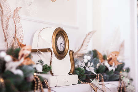 Winter background. White clocks with decorated branches of Christmas tree. Close-upの写真素材