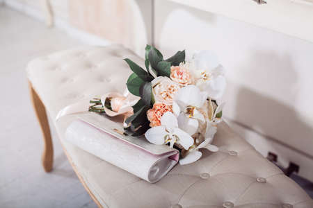 Wedding background. Bridal clutch and bouquet of fresh white flowers on the benchの写真素材