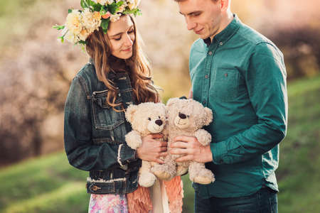 Double romantic date. Happy girl with boyfriend and two plush teddy bear. Love and tenderness.の写真素材