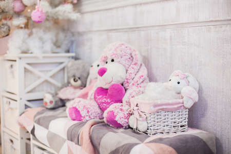 Plush toys sits at the bench covered with plaidの写真素材