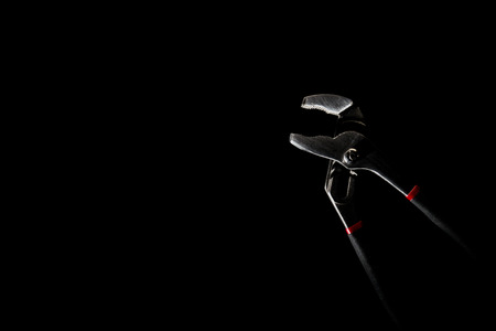 Locking Pliers on the black background with hi-contrast and low key style. With copy space.の写真素材