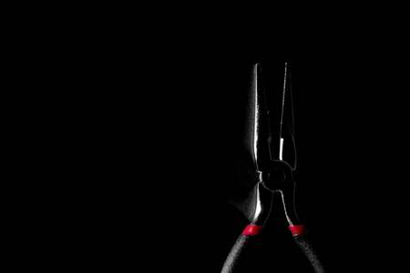 Pliers on the black background. Low key and high contrast style with copy space.の写真素材