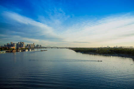 Fishing boat building on the banks of the Songhua River of blue sky and white cloudsの写真素材