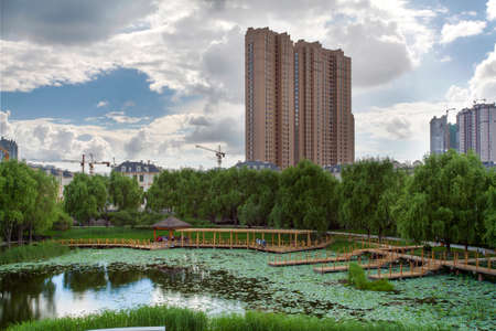 City building wetlands reflection,blue sky and white cloudsのeditorial素材