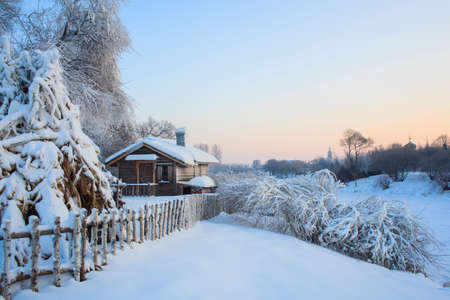 Sunset fence wooden chopping snow rimeのeditorial素材