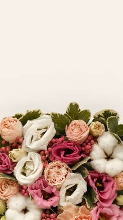 Closeup of bouquet of flowers in rustic style on white background. Vertical for stories. Copy space. Spring flowers. Bouquet element.の写真素材