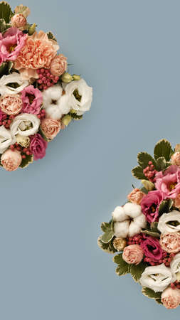 Closeup of bouquet of flowers in rustic style on blue background. Vertical for stories. Copy space z-form. Spring flowers. Bouquet element.の写真素材