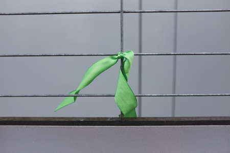 Green ribbon in honor of anti-war action in Russia against military actions in Ukraineの写真素材