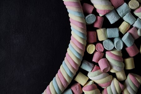 Marshmallows. of colorful mini marshmallows,top view  on a black background ,  With space to...