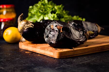 Grilled eggplant on a wooden board on black background - Imageの写真素材