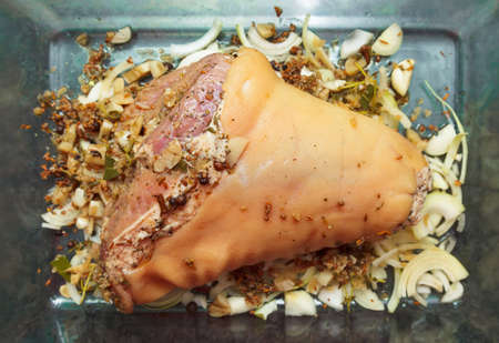 Marinated raw pork knuckle before roast with spiciesの写真素材