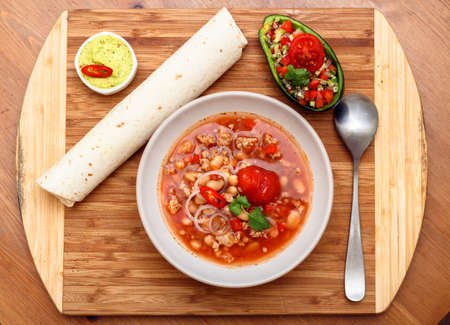 chili con carne soup garnish with tortilla, guakomolle and saladの写真素材