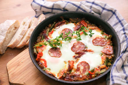 Spanish Food: eggs over Flemish, a pan closeup. horizontalの写真素材