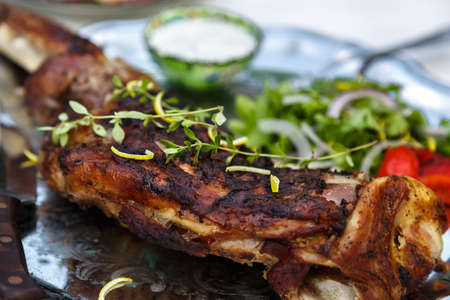 Roasted lamb shoulder with baked pepper, coriander, onion and breadの写真素材
