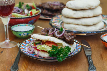 meat skewer with herbs, lime and pita bread.の写真素材