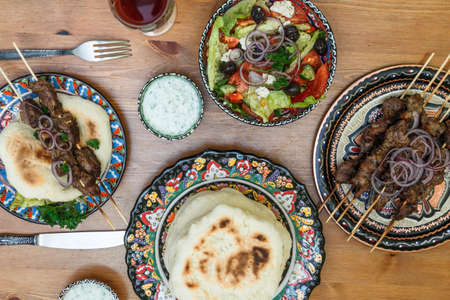 Souvlaki or kebab, meat skewer with pita bread and fresh vegetableの写真素材