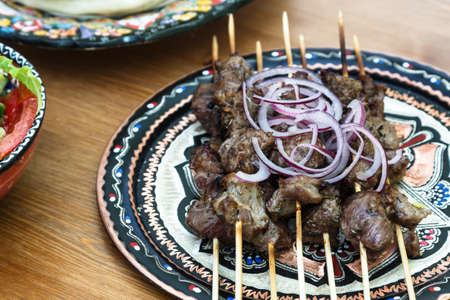 shish kebab skewers on beautiful traditional turkish plateの写真素材