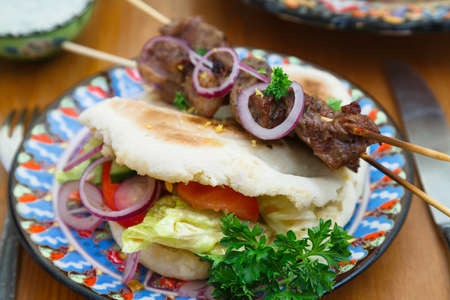 Souvlaki or kebab, grilled meat skewer and pita bread.の写真素材