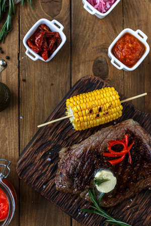Grilled Black Angus Steak on wooden background. Top viewの写真素材