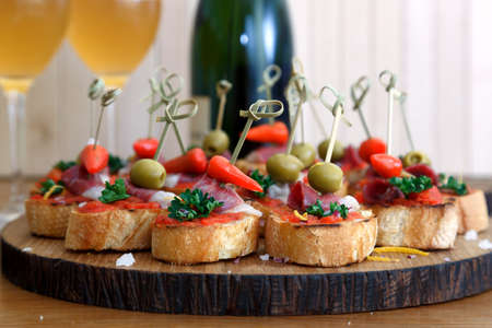 Tapas on Crusty Bread - Selection of Spanish tapas served on a sliced baguette