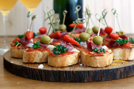 Tapas on Crusty Bread - Selection of Spanish tapas served on a sliced baguetteの写真素材