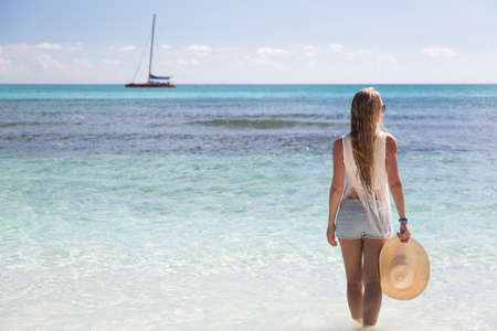Girl stand in water looking to the sea, Saona, Dominican Republicの写真素材