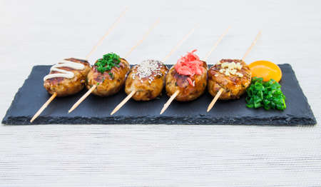 Japanese skewers of chicken with soy sauce and sesame seeds.の写真素材