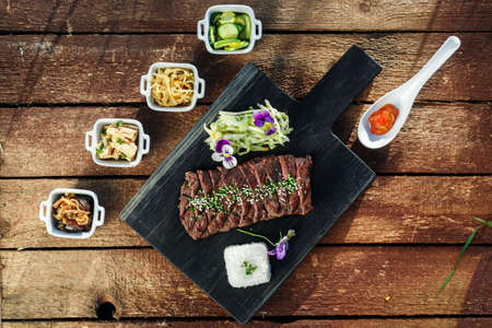 Korean BBQ with full side dishes on wooden backgroundの写真素材