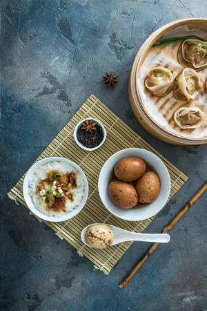 Chinese Streamed Dumpling with tea eggs and porrige, top viewの写真素材