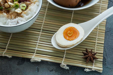 Cutted tea egg with star anise on bamboo mat.の写真素材