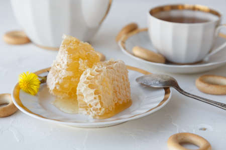 Tea with honey on white background