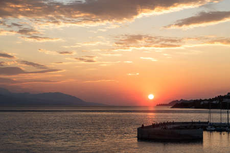 Beautiful sunset with sea and pier, Loutraki, Grecee.の写真素材