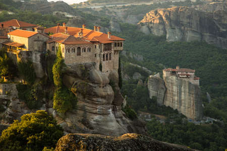 Meteora monasteries. Beautiful morning view on the Holy Monastery of Varlaam placed on the edge of high rock, Roussanou Monastery on background. Kastraki, Greeceの写真素材