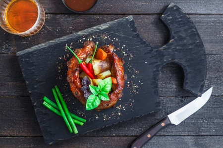 Crown roast of pork with grilled vegetables and whiskey sauce, top close viewの写真素材
