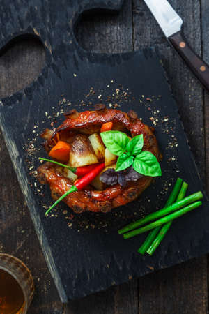 Crown roast of pork with grilled vegetables and whiskey sauceの写真素材