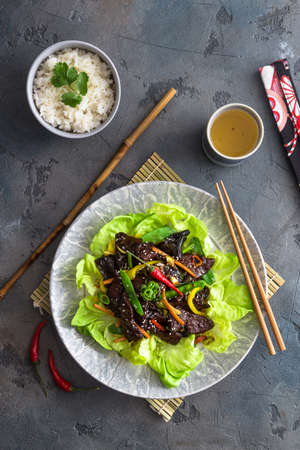 Asian stir fried chicken liver with bowl of rice and green teaの写真素材
