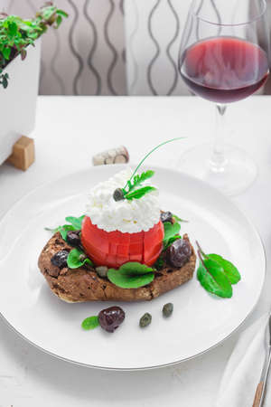 Dakos barley rusk with mizitra cheese, tomato, olives, oregano and olive oil. Cretan appetizerの写真素材