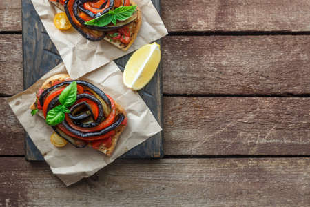 Two Bruschettas with grilled eggplant and bell peppers top view, place for text.の写真素材